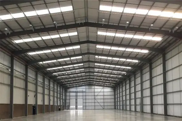 A spacious prefabricated steel structure with two doors and several windows, suitable for industrial
purposes, showcasing ShadeCo's efficient prefabricated structures