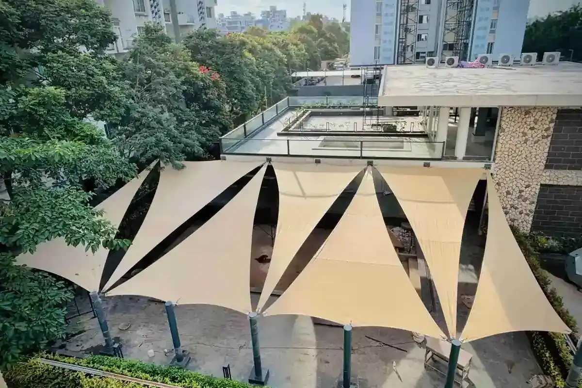 Tensile shade sails installation providing outdoor sun protection in residential courtyard